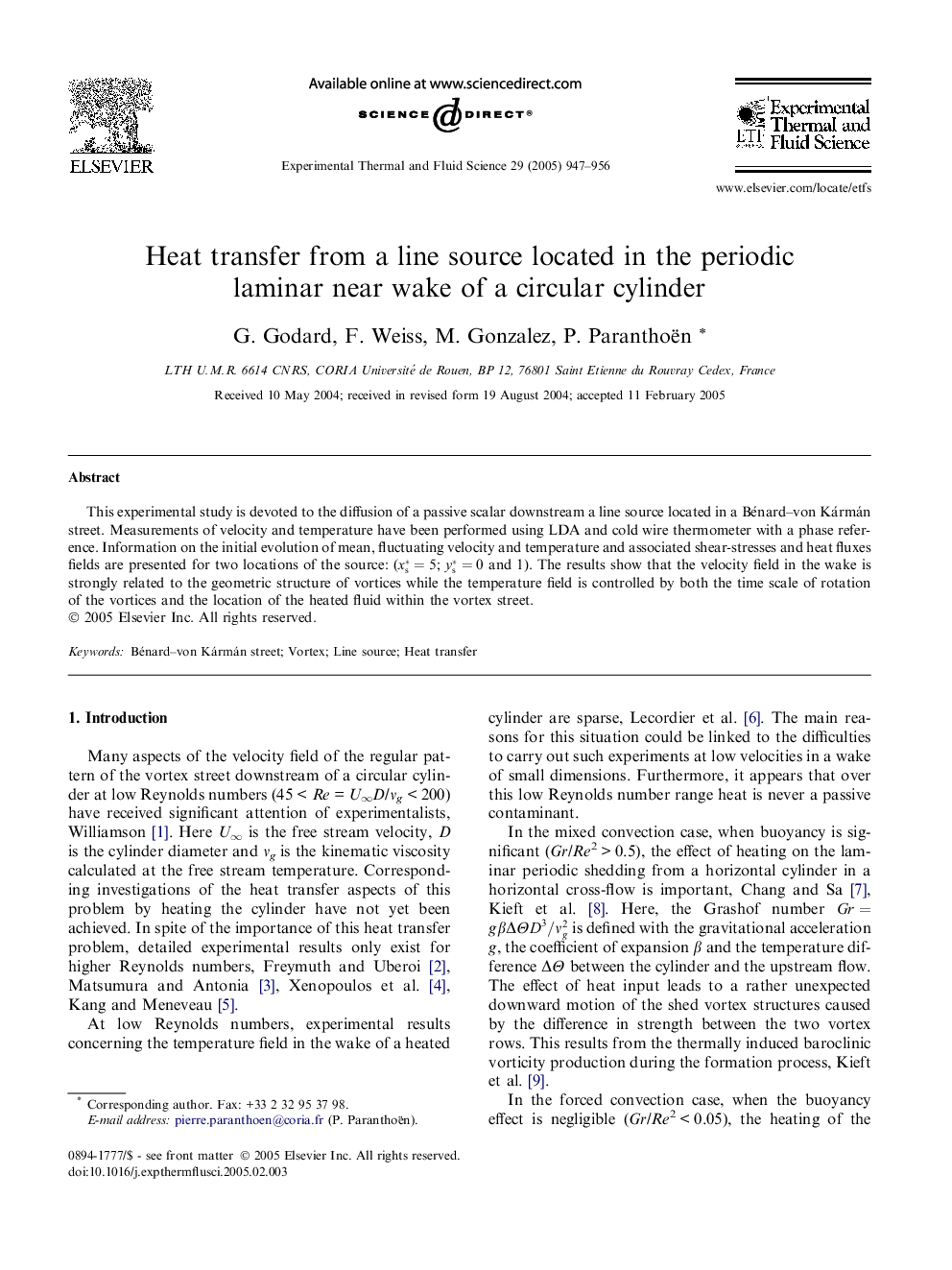 Heat transfer from a line source located in the periodic laminar near wake of a circular cylinder