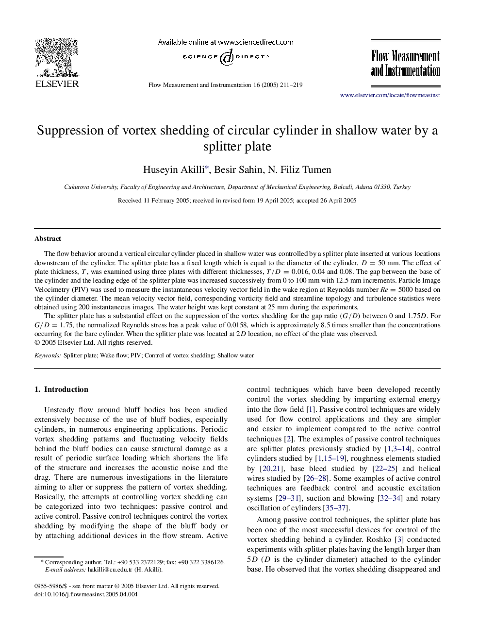 Suppression of vortex shedding of circular cylinder in shallow water by a splitter plate