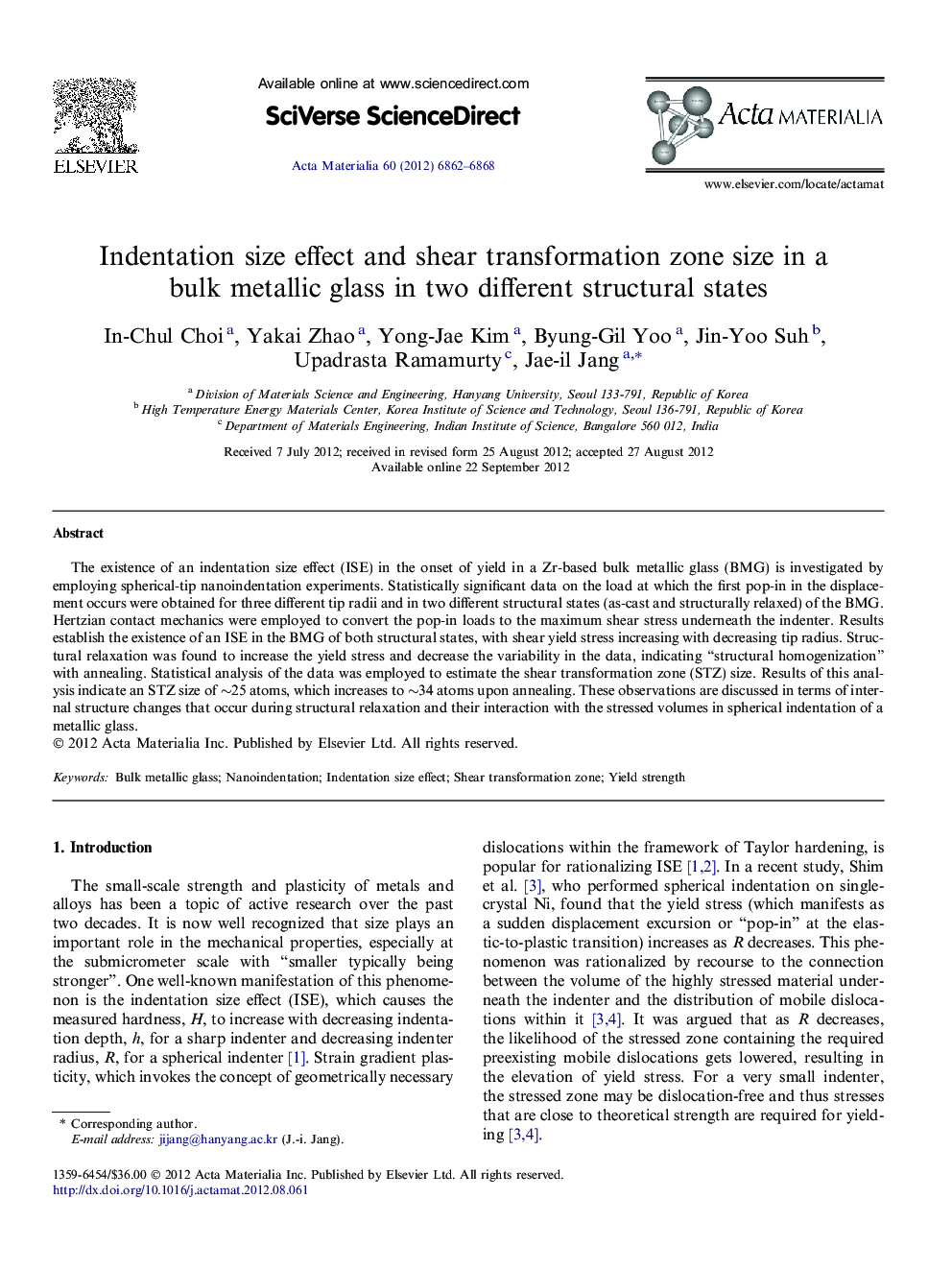 Indentation size effect and shear transformation zone size in a bulk metallic glass in two different structural states