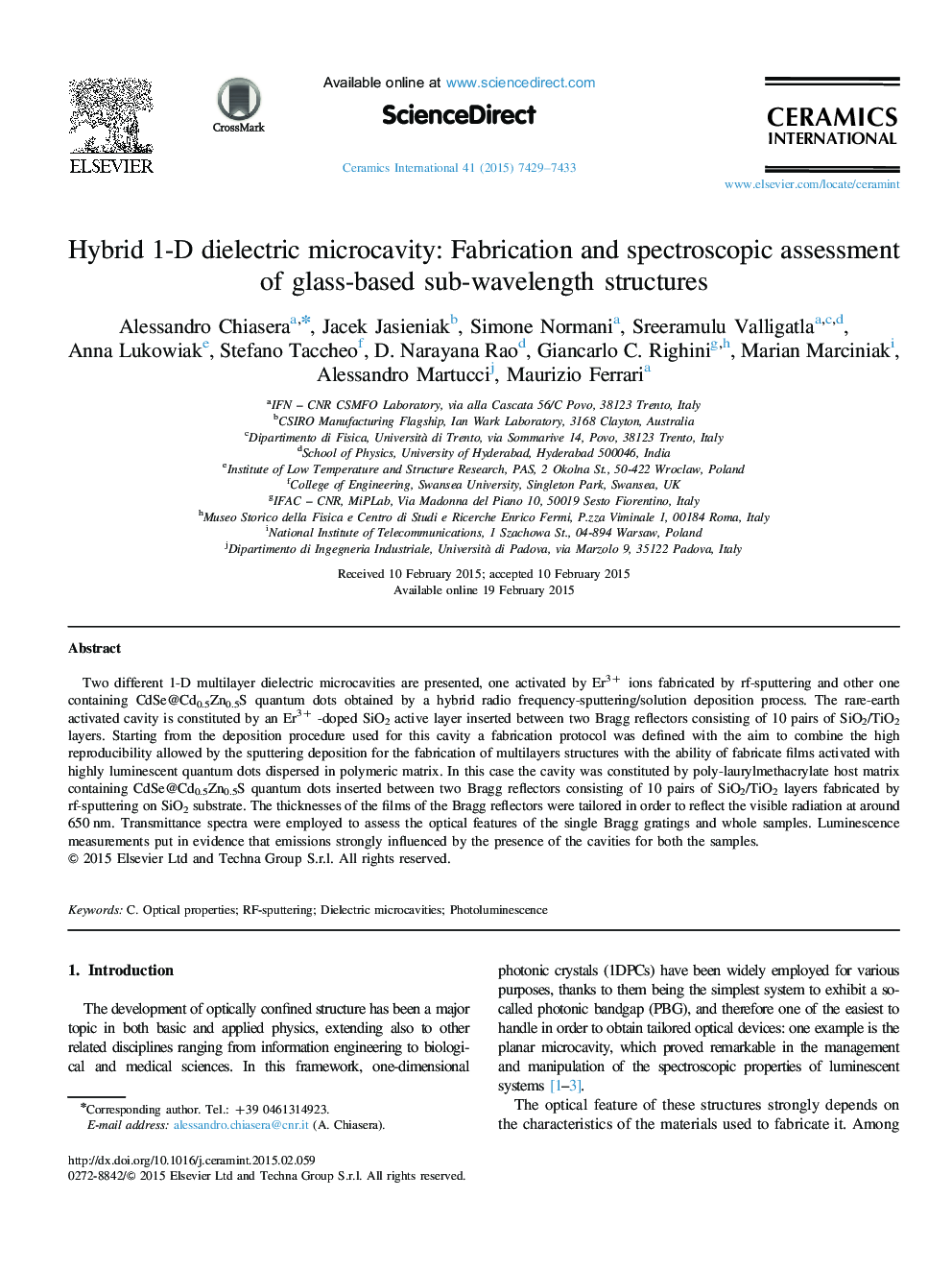 Hybrid 1-D dielectric microcavity: Fabrication and spectroscopic assessment of glass-based sub-wavelength structures