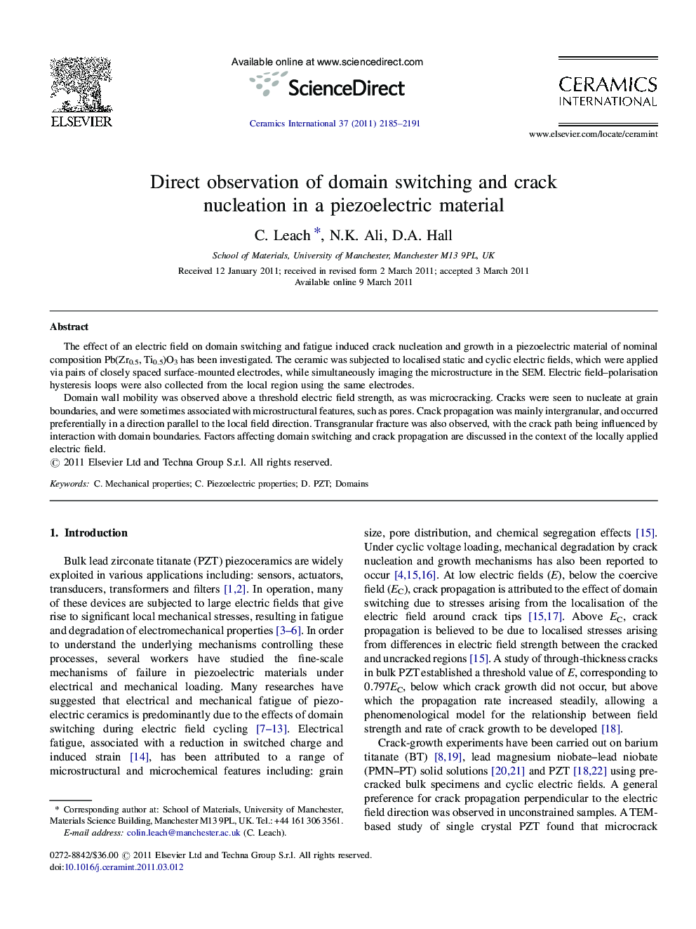 Direct observation of domain switching and crack nucleation in a piezoelectric material