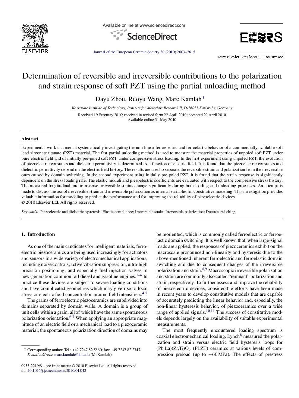 Determination of reversible and irreversible contributions to the polarization and strain response of soft PZT using the partial unloading method