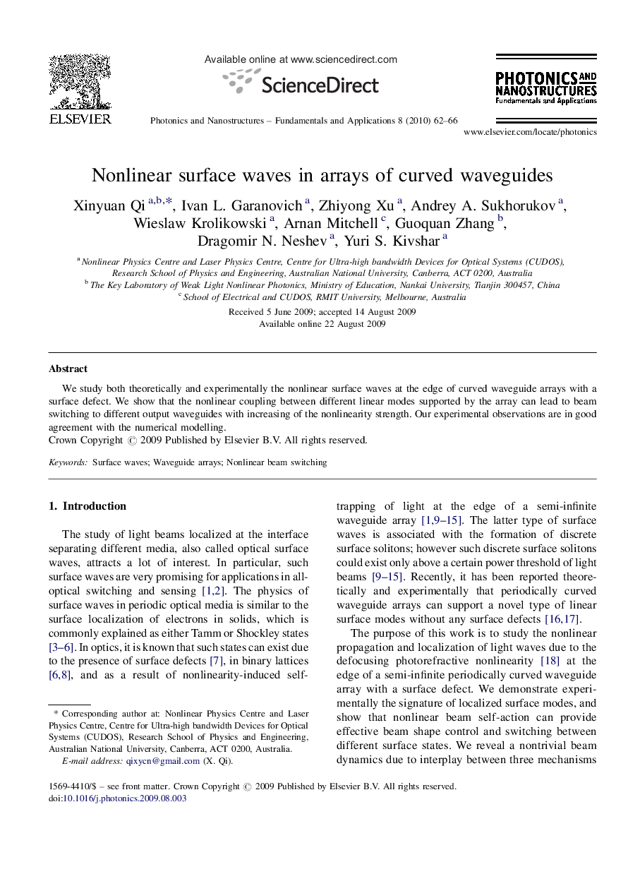 Nonlinear surface waves in arrays of curved waveguides