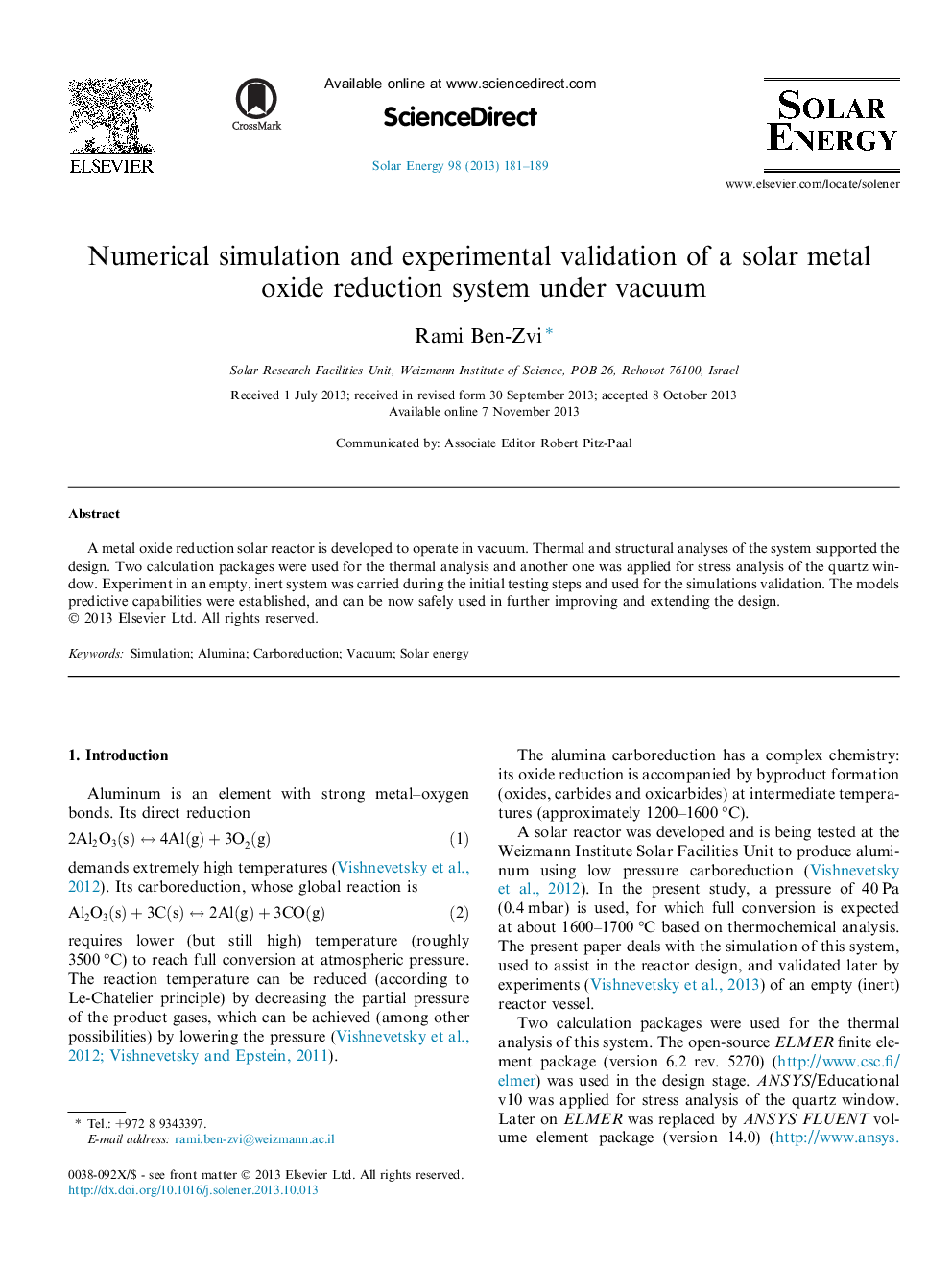 Numerical simulation and experimental validation of a solar metal oxide reduction system under vacuum