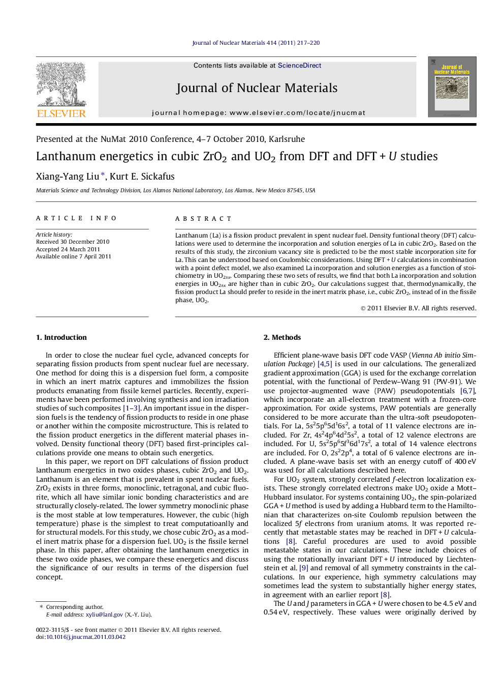 Lanthanum energetics in cubic ZrO2 and UO2 from DFT and DFT + U studies