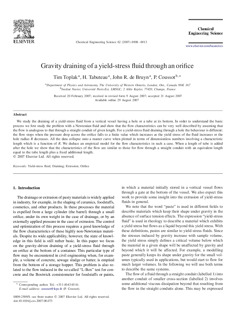 Gravity draining of a yield-stress fluid through an orifice