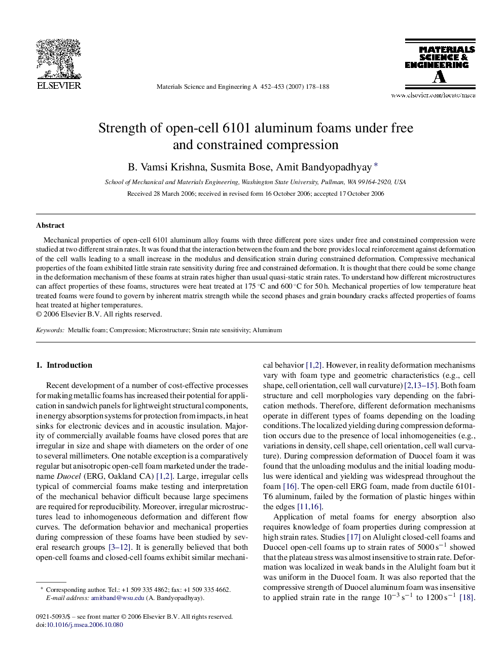 Strength of open-cell 6101 aluminum foams under free and constrained compression