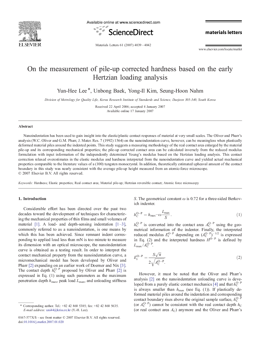 On the measurement of pile-up corrected hardness based on the early Hertzian loading analysis