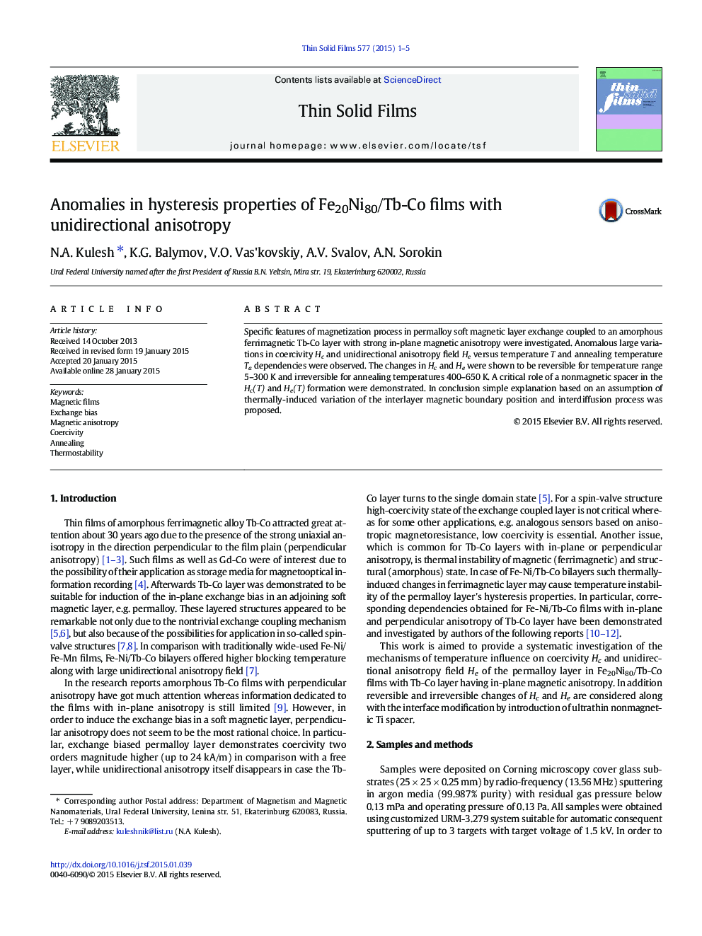 Anomalies in hysteresis properties of Fe20Ni80/Tb-Co films with unidirectional anisotropy