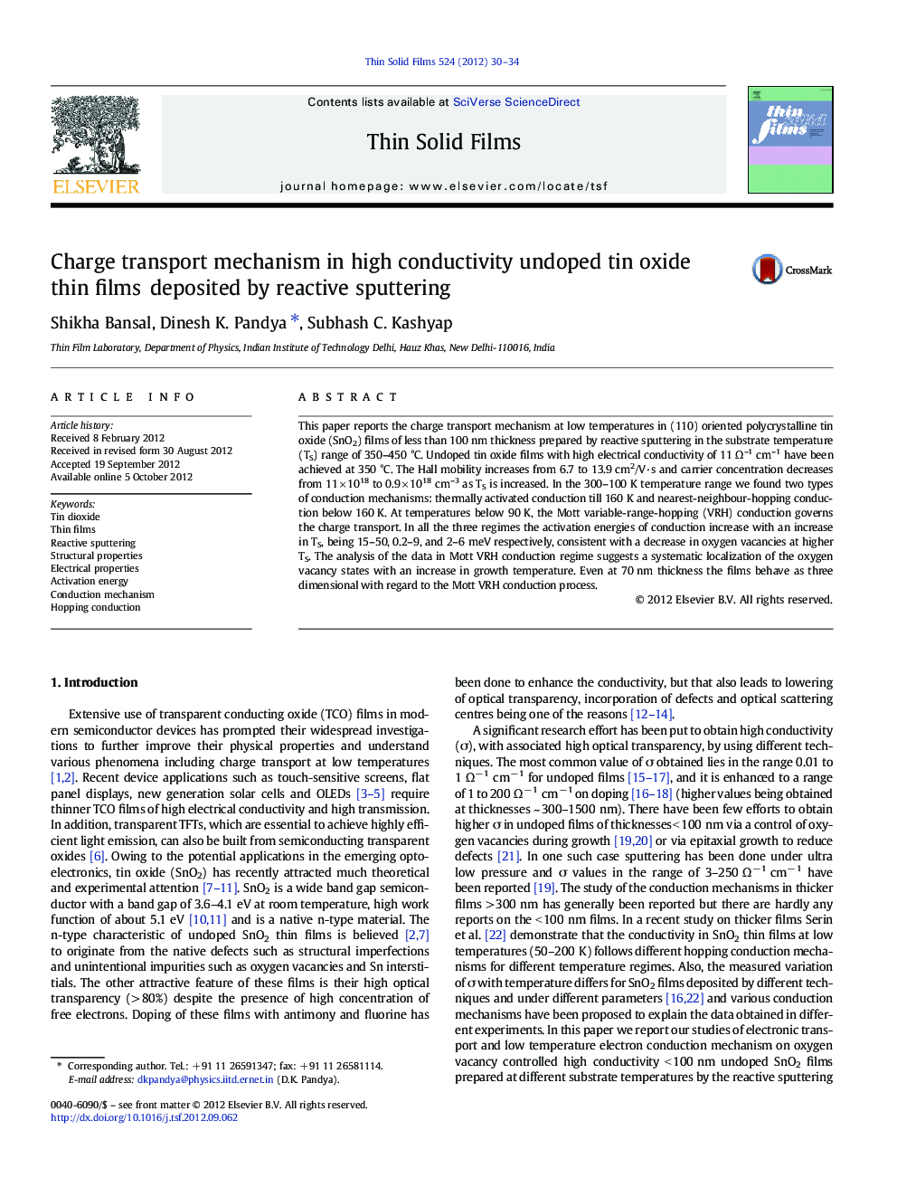 Charge transport mechanism in high conductivity undoped tin oxide thin films deposited by reactive sputtering