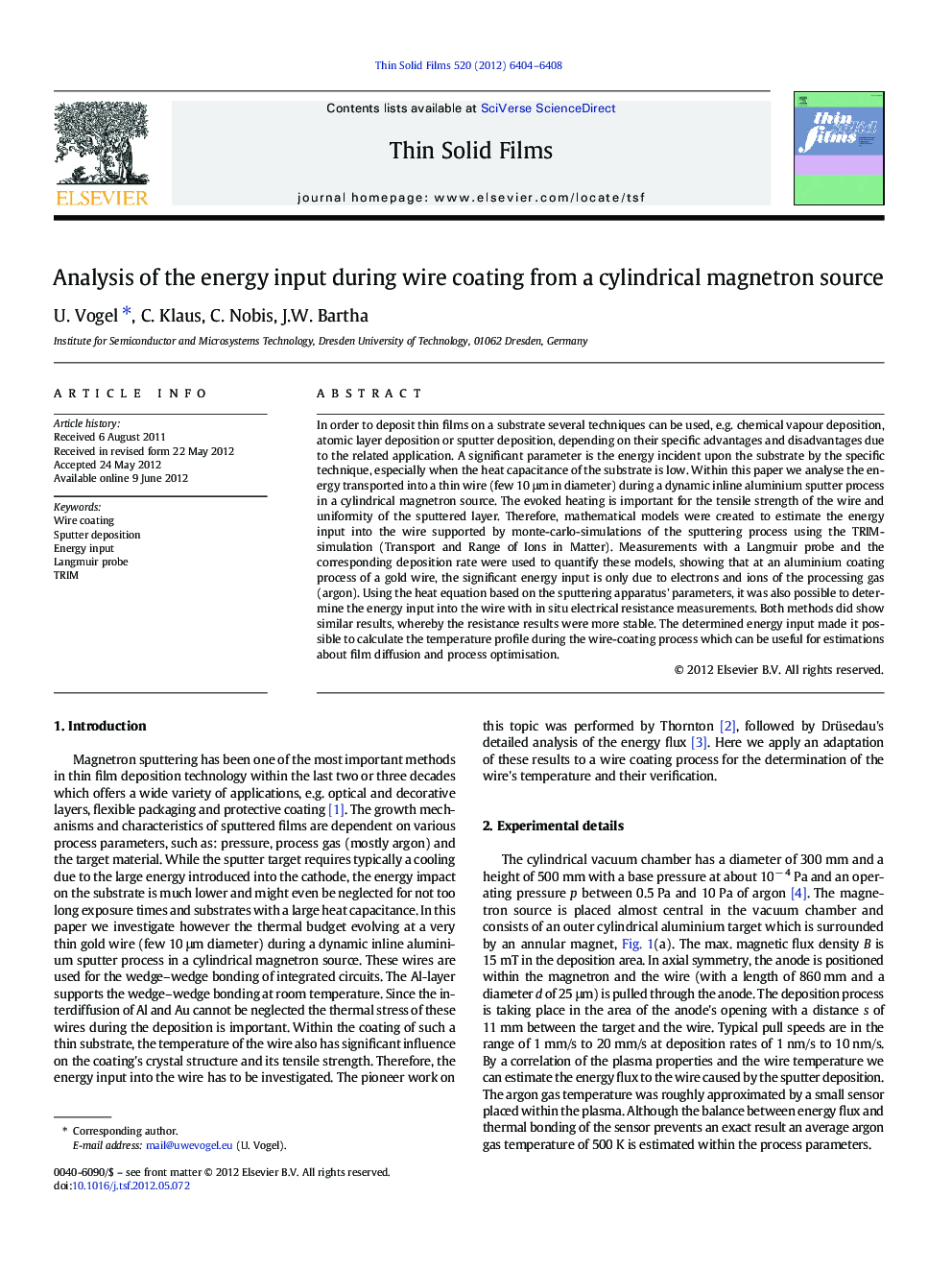 Analysis of the energy input during wire coating from a cylindrical magnetron source