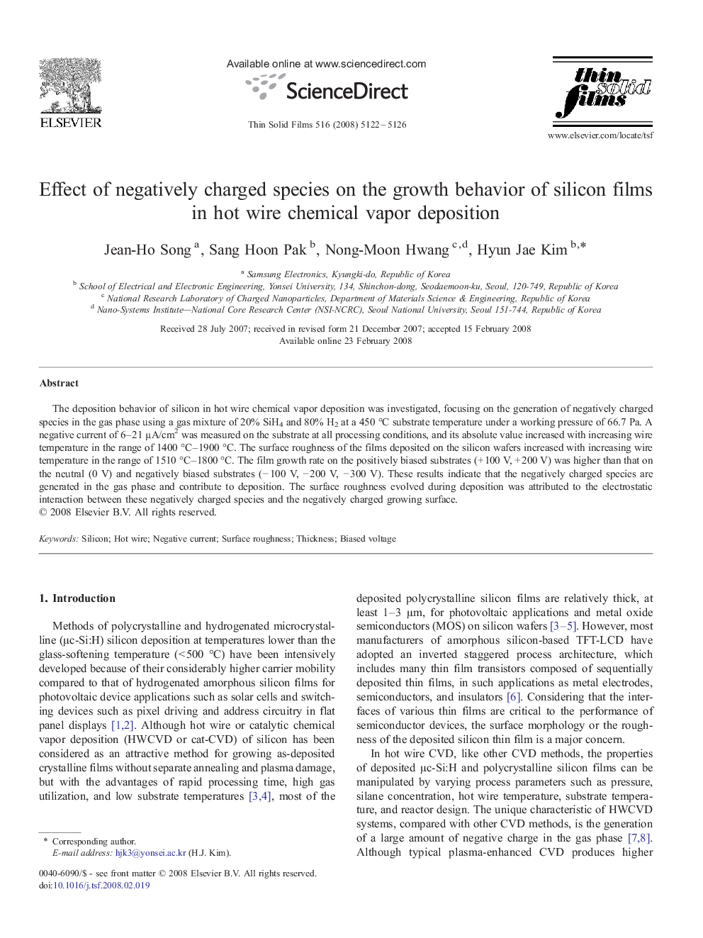 Effect of negatively charged species on the growth behavior of silicon films in hot wire chemical vapor deposition