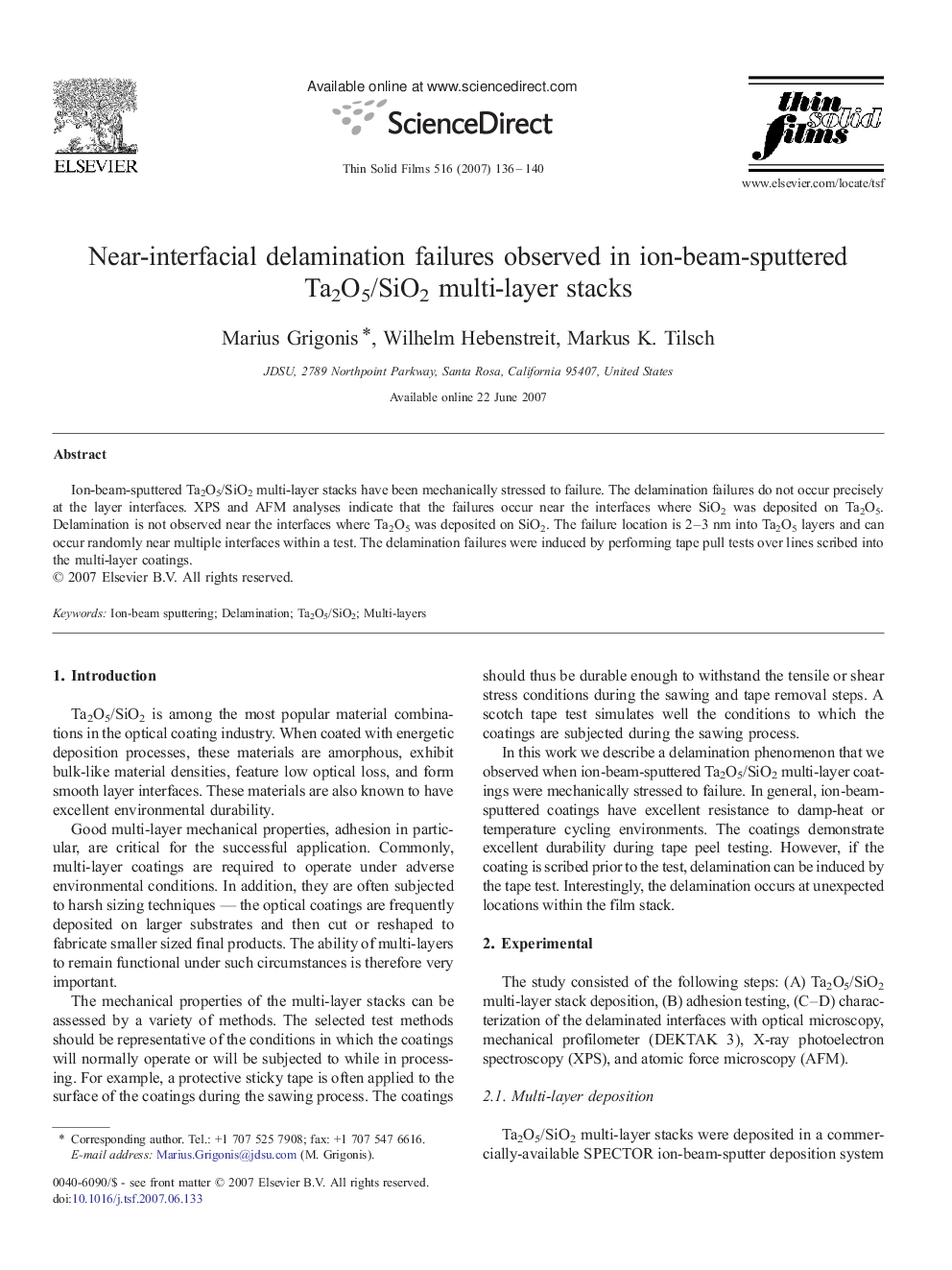 Near-interfacial delamination failures observed in ion-beam-sputtered Ta2O5/SiO2 multi-layer stacks