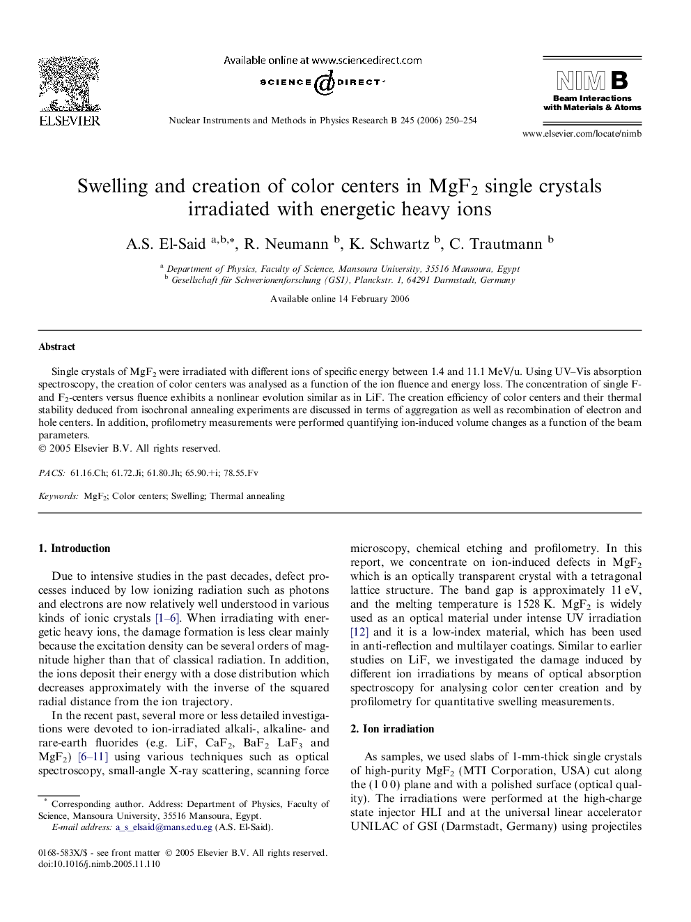 Swelling and creation of color centers in MgF2 single crystals irradiated with energetic heavy ions