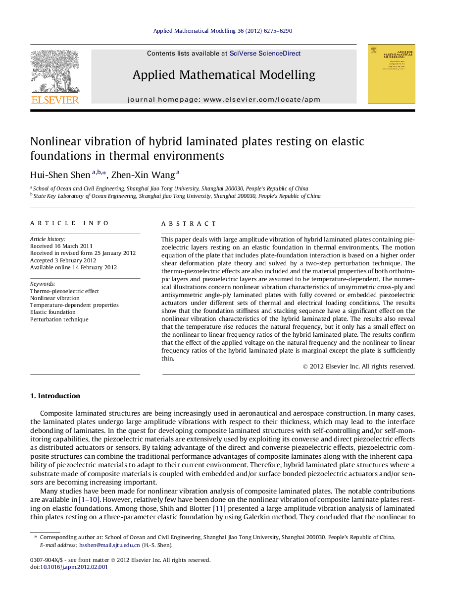 Nonlinear vibration of hybrid laminated plates resting on elastic foundations in thermal environments