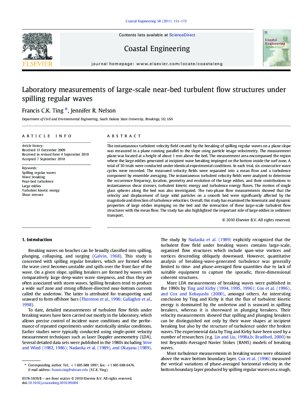 Laboratory measurements of large-scale near-bed turbulent flow structures under spilling regular waves