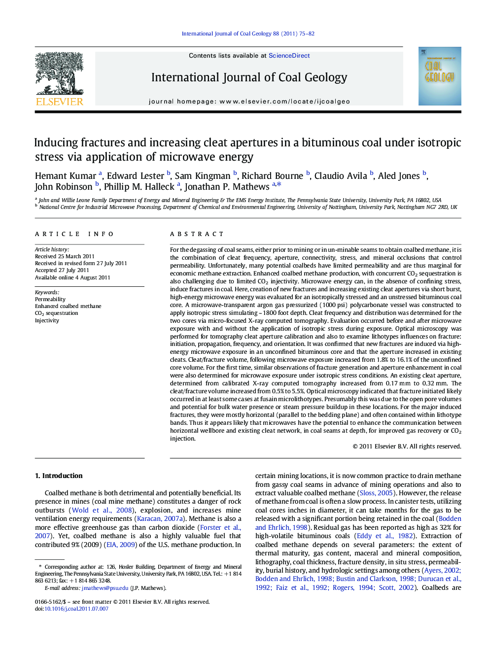 Inducing fractures and increasing cleat apertures in a bituminous coal under isotropic stress via application of microwave energy