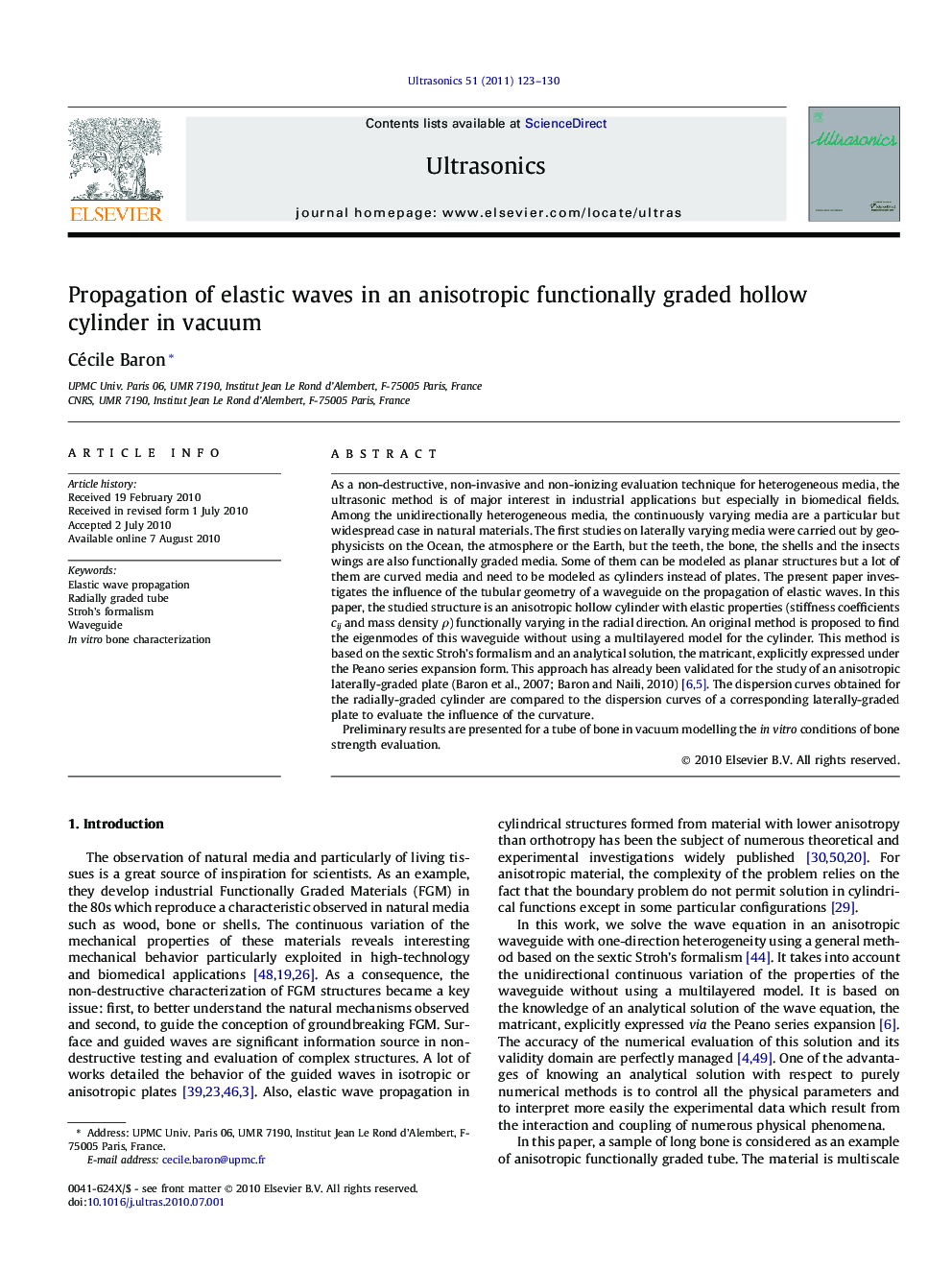 Propagation of elastic waves in an anisotropic functionally graded hollow cylinder in vacuum