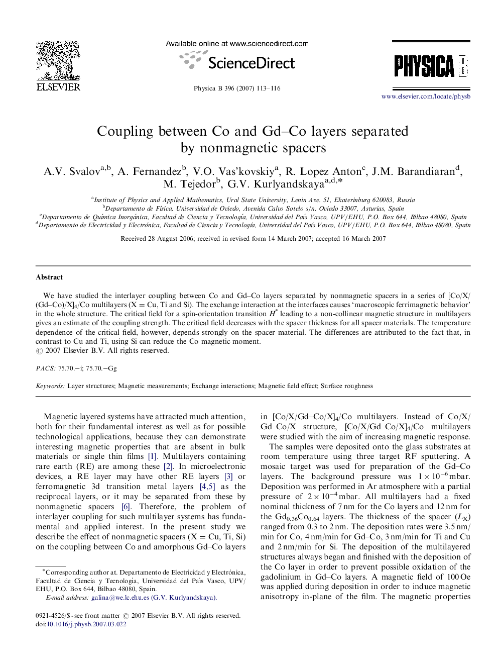 Coupling between Co and Gd-Co layers separated by nonmagnetic spacers