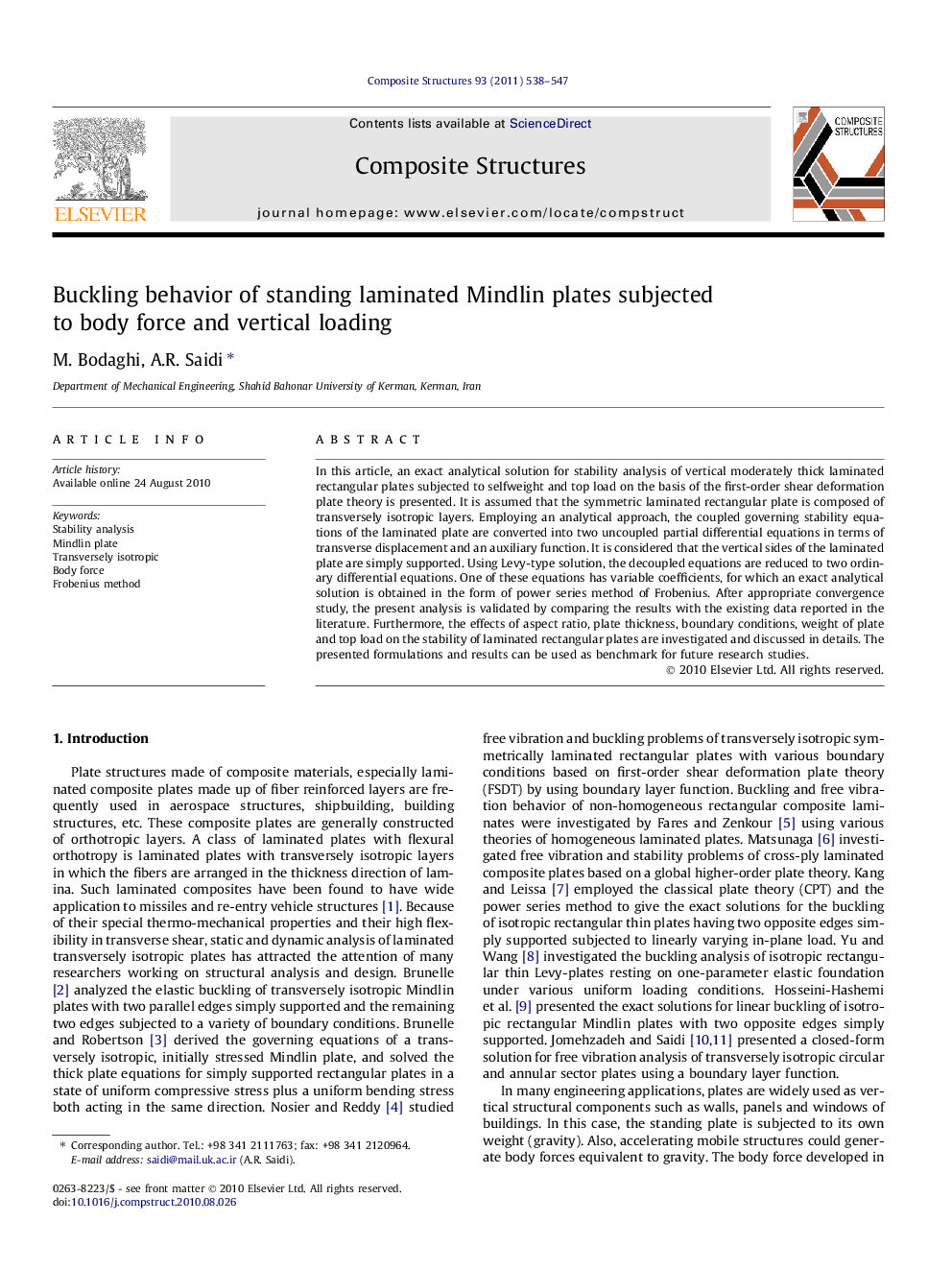 Buckling behavior of standing laminated Mindlin plates subjected to body force and vertical loading