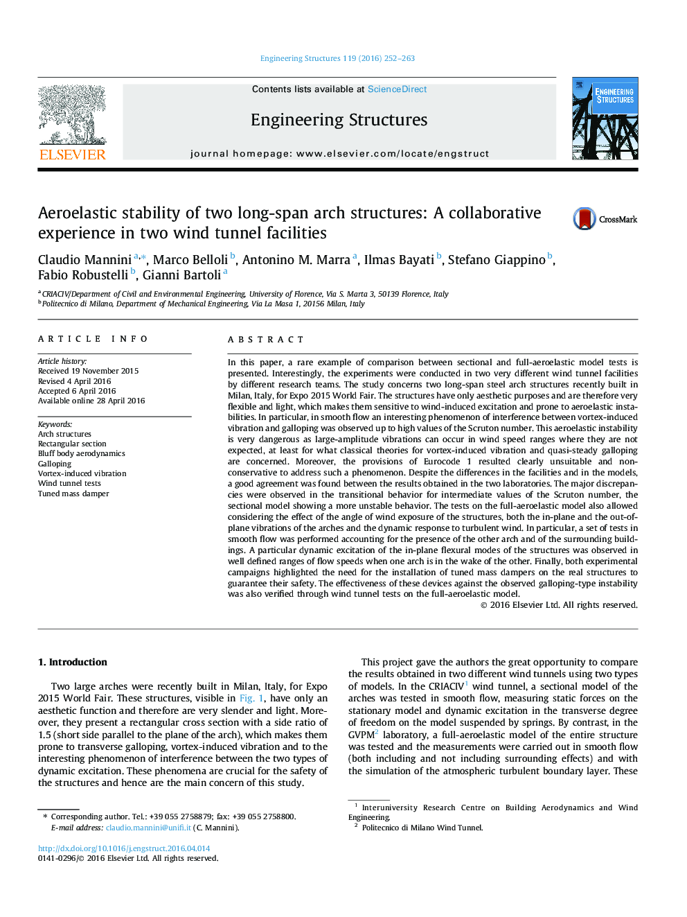 Aeroelastic stability of two long-span arch structures: A collaborative experience in two wind tunnel facilities