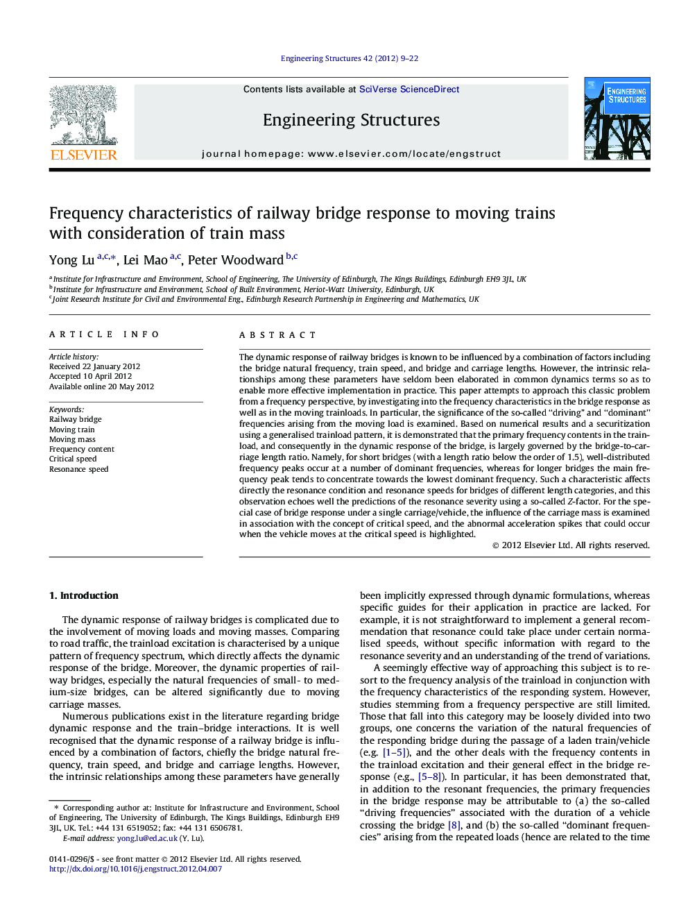 Frequency characteristics of railway bridge response to moving trains with consideration of train mass