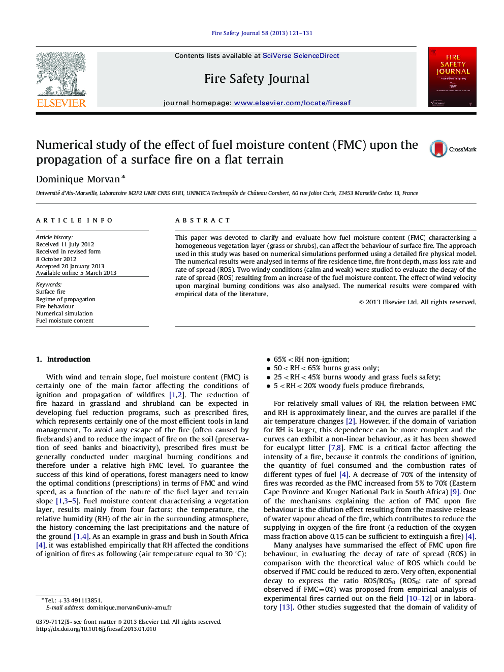 Numerical study of the effect of fuel moisture content (FMC) upon the propagation of a surface fire on a flat terrain