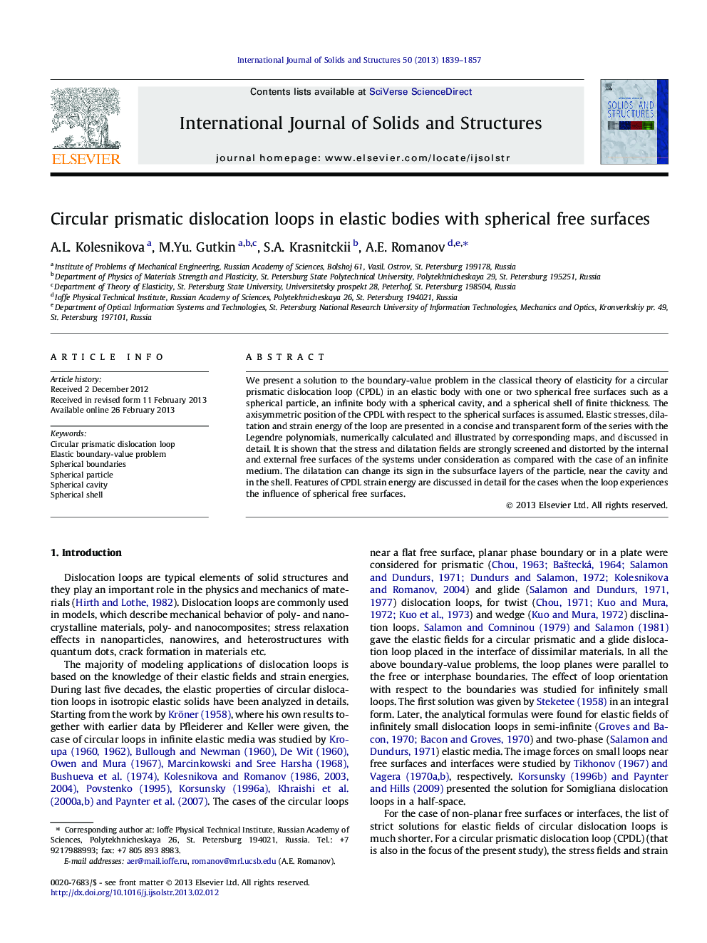 Circular prismatic dislocation loops in elastic bodies with spherical free surfaces