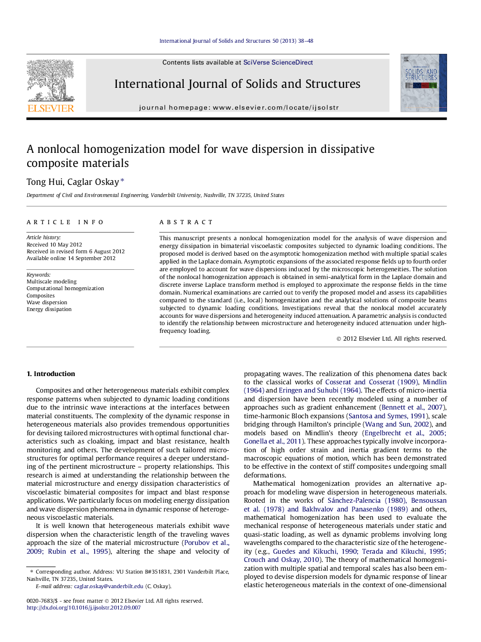 A nonlocal homogenization model for wave dispersion in dissipative composite materials