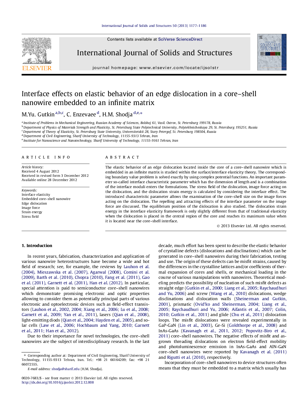 Interface effects on elastic behavior of an edge dislocation in a core–shell nanowire embedded to an infinite matrix