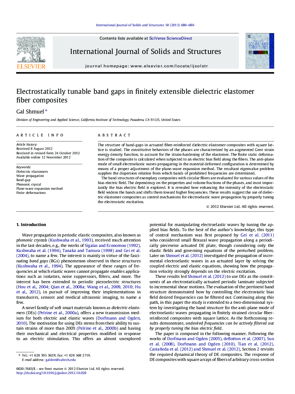 Electrostatically tunable band gaps in finitely extensible dielectric elastomer fiber composites