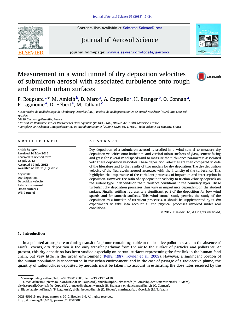 Measurement in a wind tunnel of dry deposition velocities of submicron aerosol with associated turbulence onto rough and smooth urban surfaces