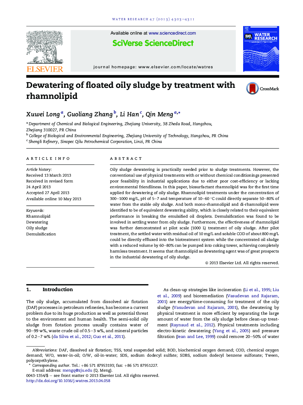 Dewatering of floated oily sludge by treatment with rhamnolipid