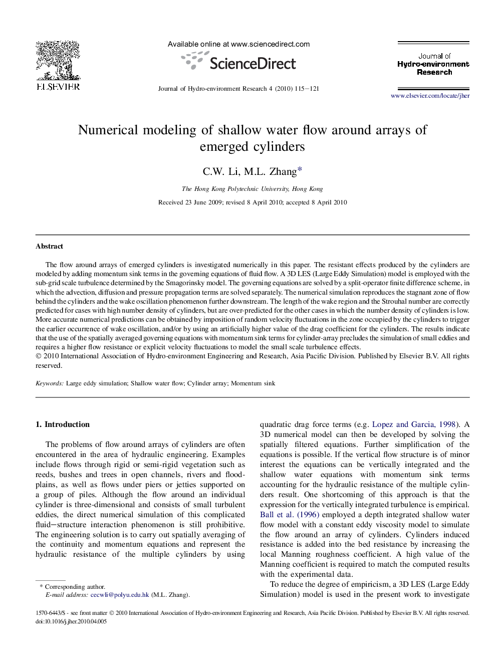 Numerical modeling of shallow water flow around arrays of emerged cylinders