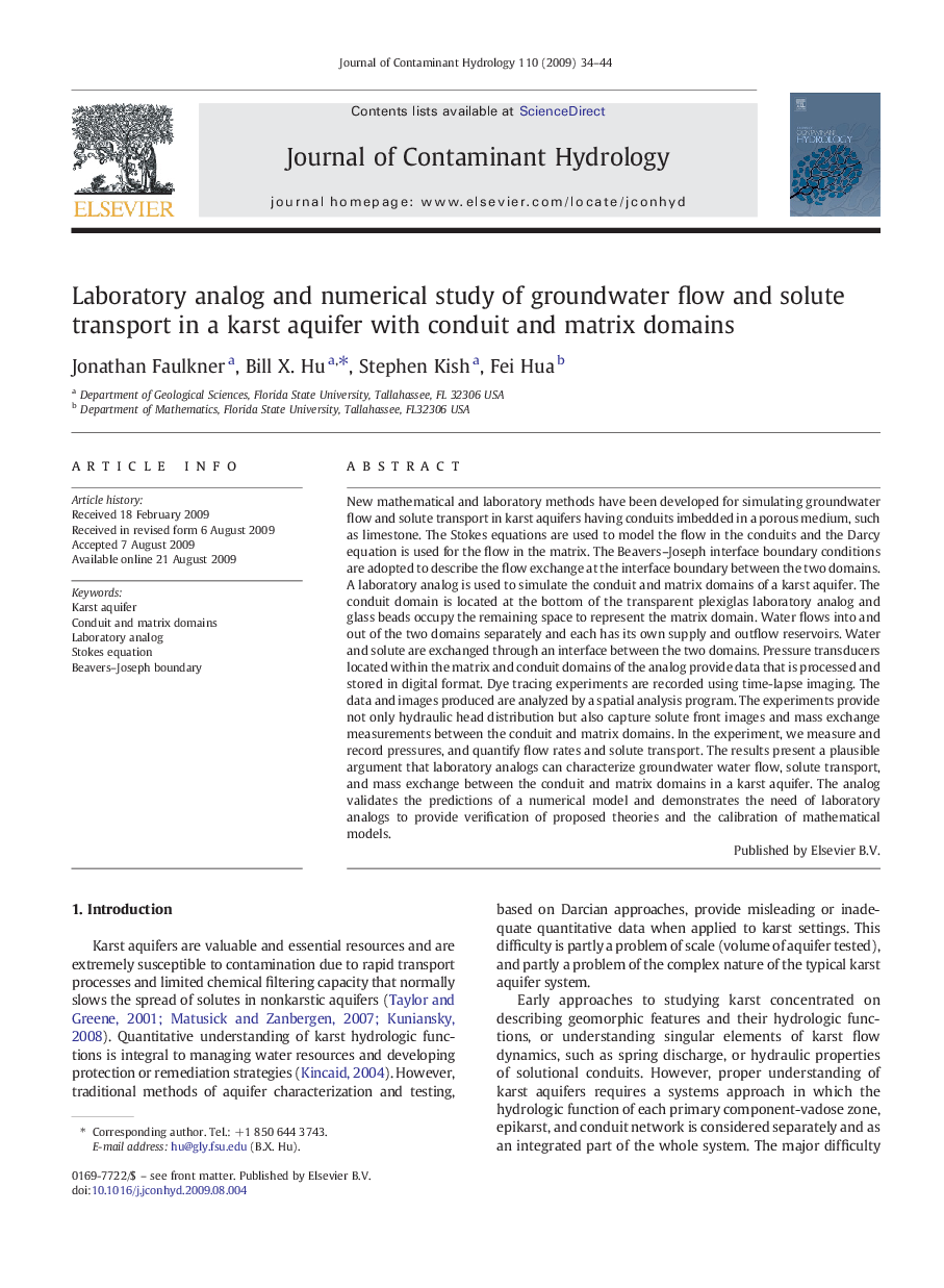 Laboratory analog and numerical study of groundwater flow and solute transport in a karst aquifer with conduit and matrix domains