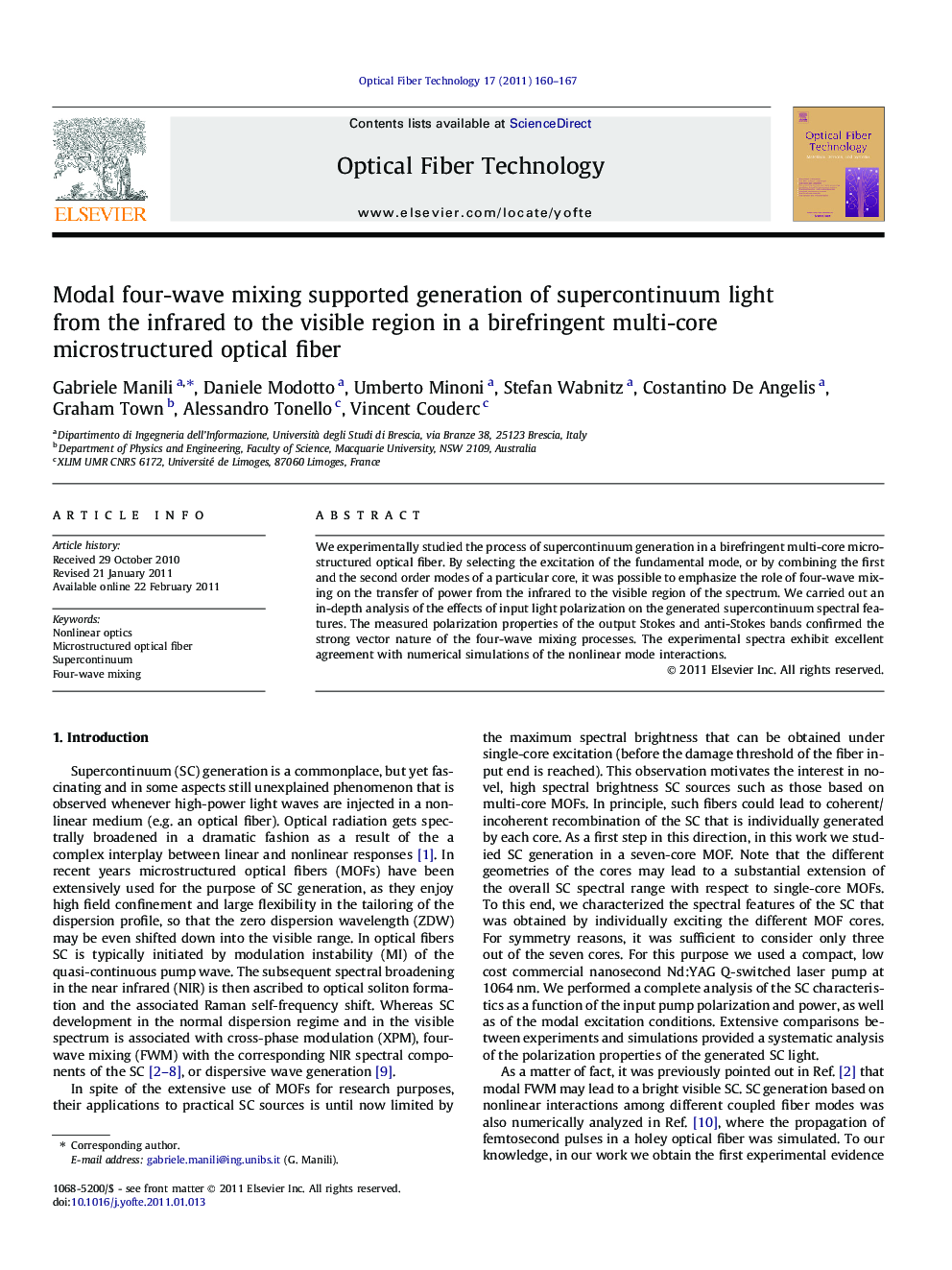 Modal four-wave mixing supported generation of supercontinuum light from the infrared to the visible region in a birefringent multi-core microstructured optical fiber