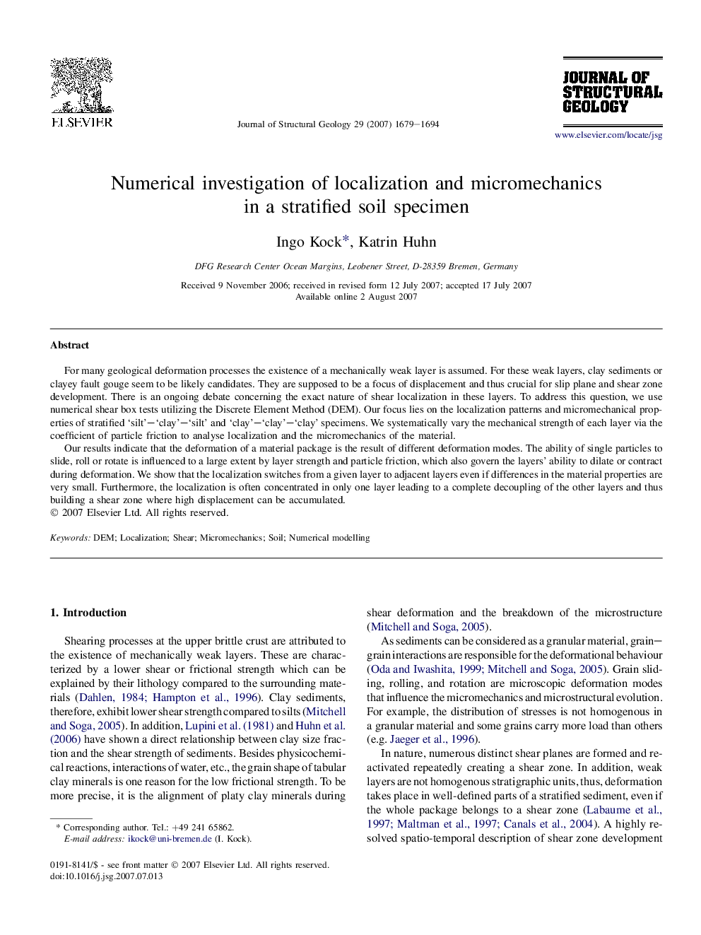 Numerical investigation of localization and micromechanics in a stratified soil specimen