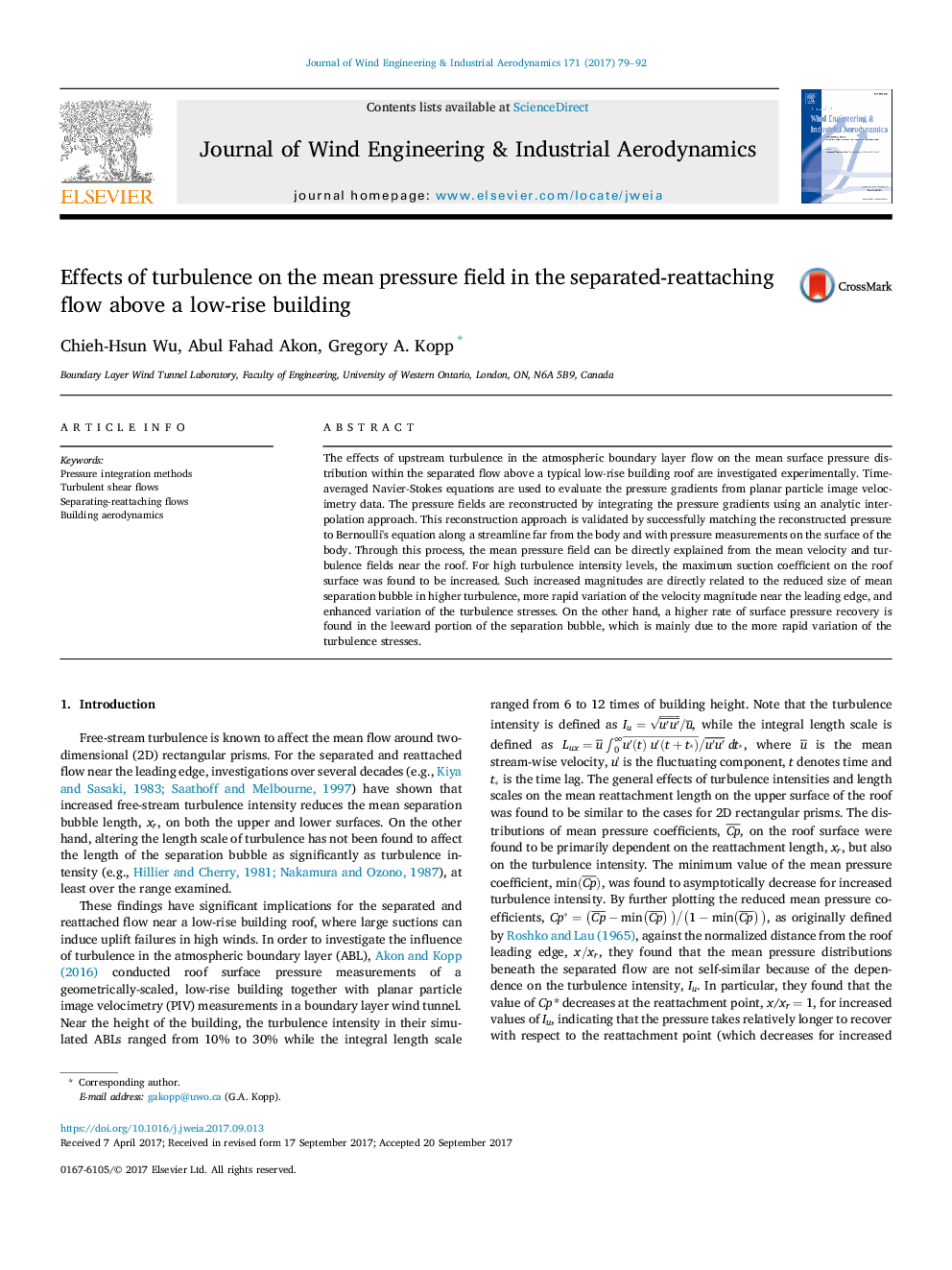 Effects of turbulence on the mean pressure field in the separated-reattaching flow above a low-rise building