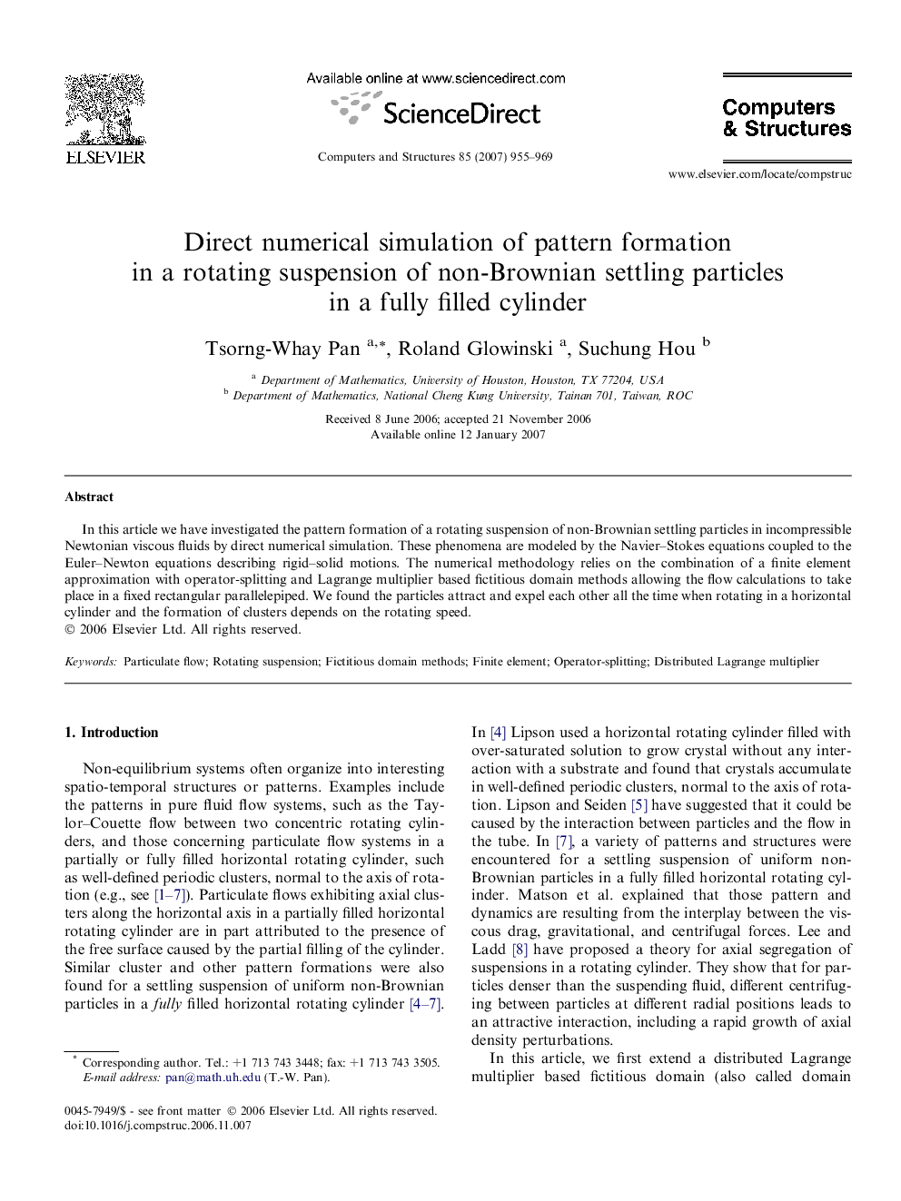 Direct numerical simulation of pattern formation in a rotating suspension of non-Brownian settling particles in a fully filled cylinder