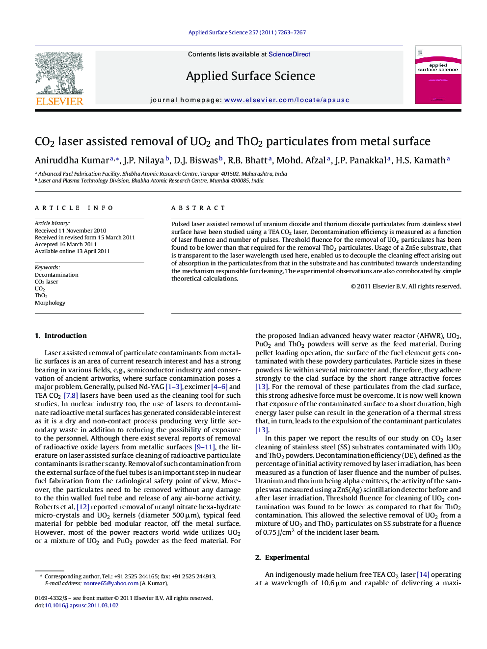 CO2 laser assisted removal of UO2 and ThO2 particulates from metal surface