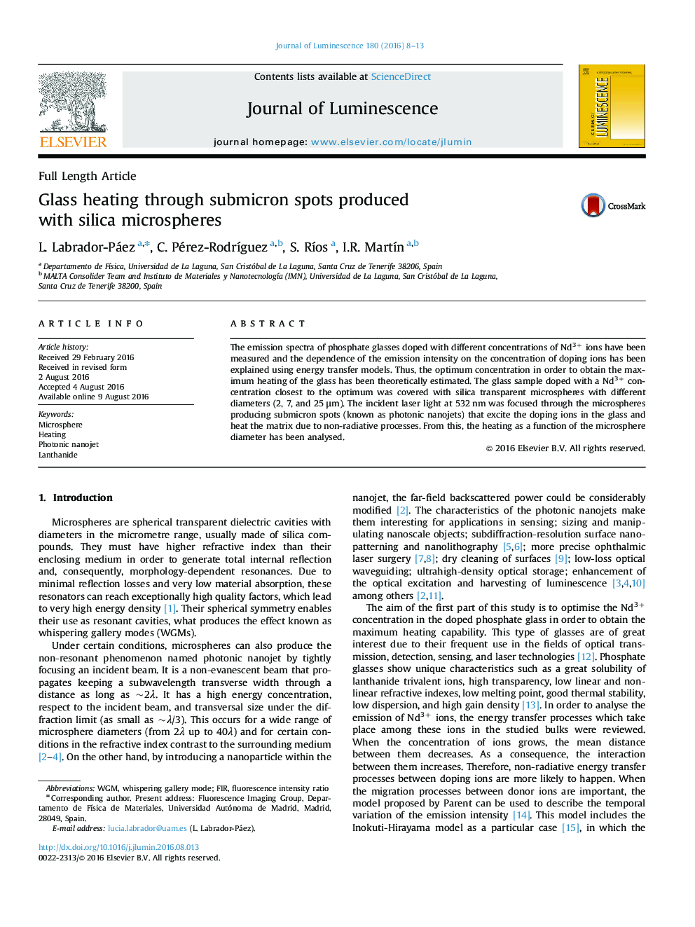 Glass heating through submicron spots produced with silica microspheres