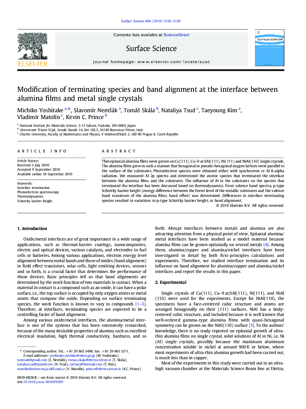 Modification of terminating species and band alignment at the interface between alumina films and metal single crystals