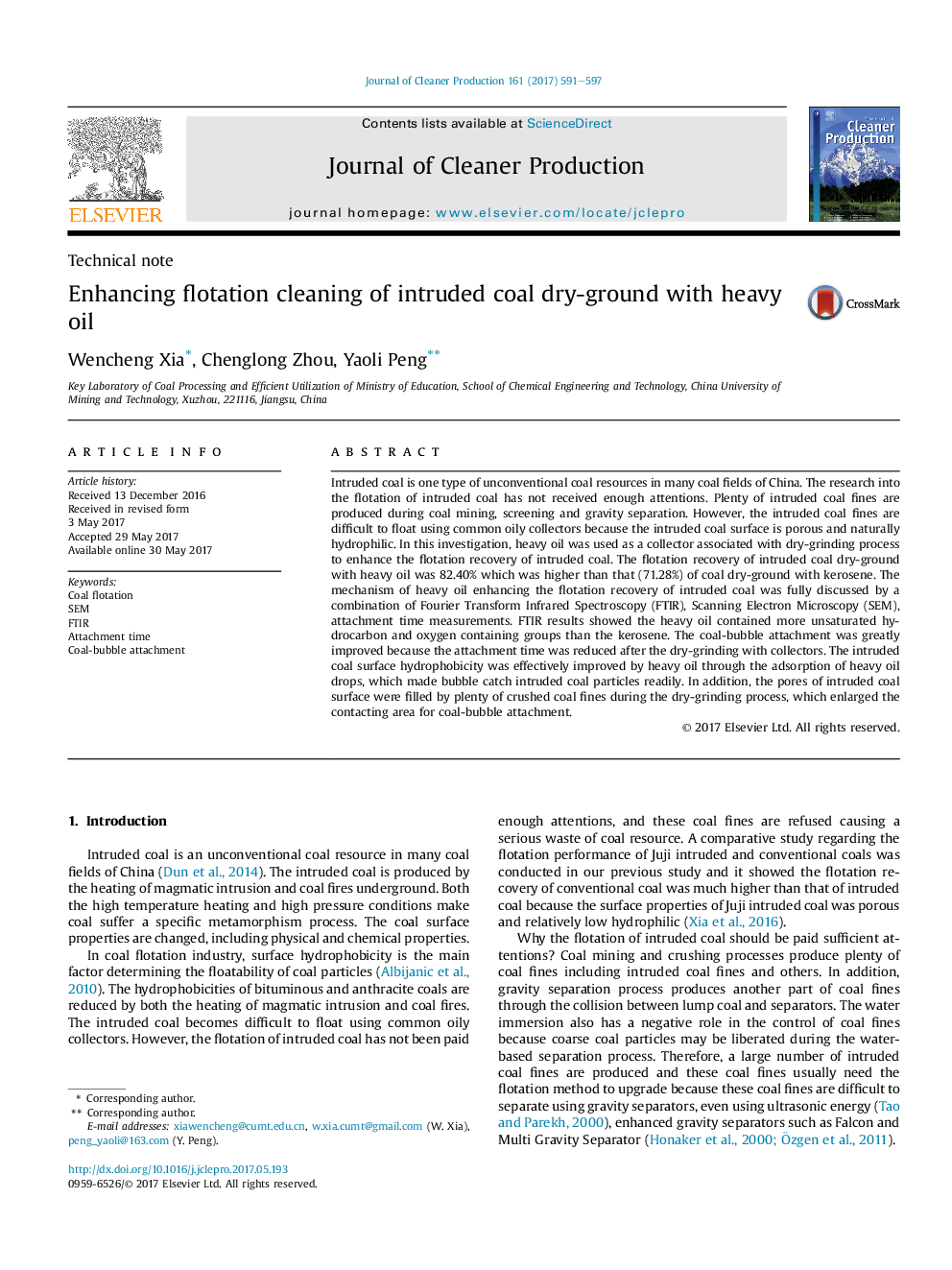 Enhancing flotation cleaning of intruded coal dry-ground with heavy oil