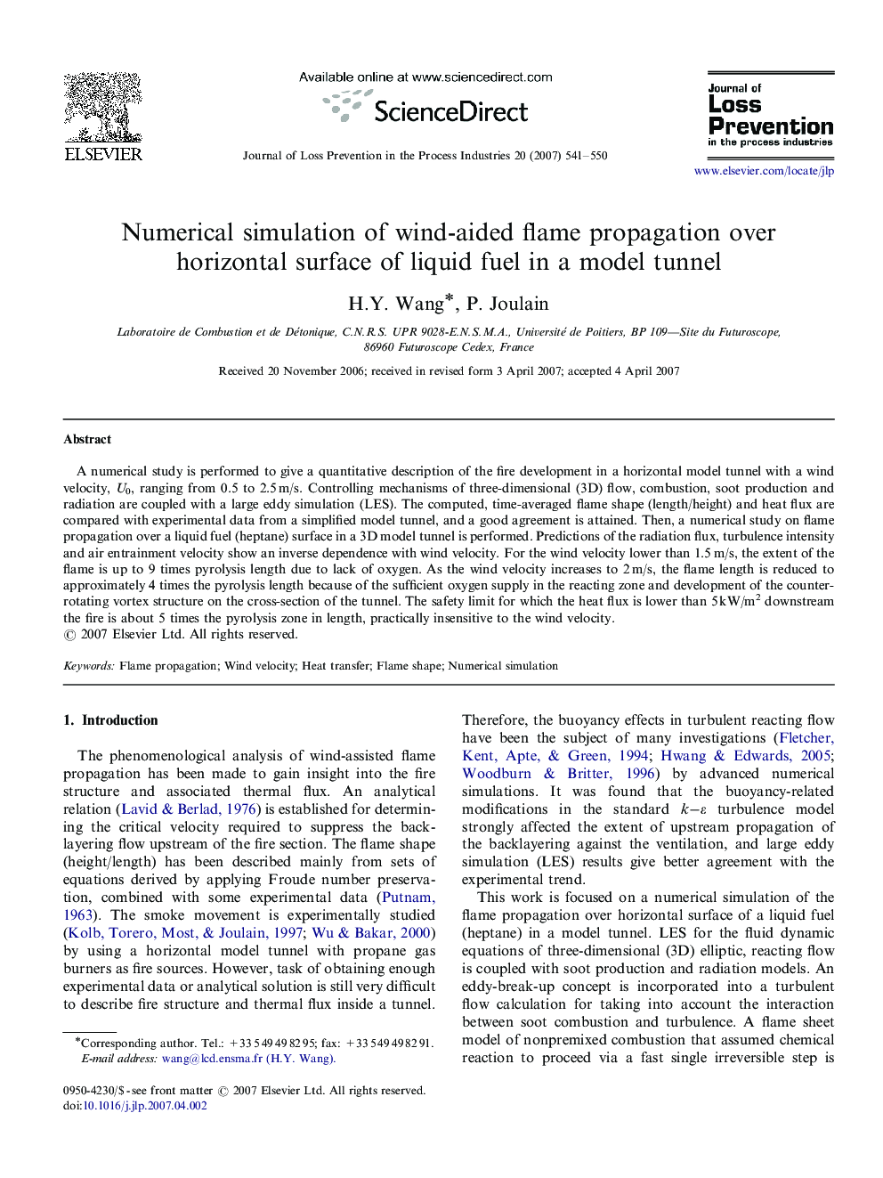 Numerical simulation of wind-aided flame propagation over horizontal surface of liquid fuel in a model tunnel