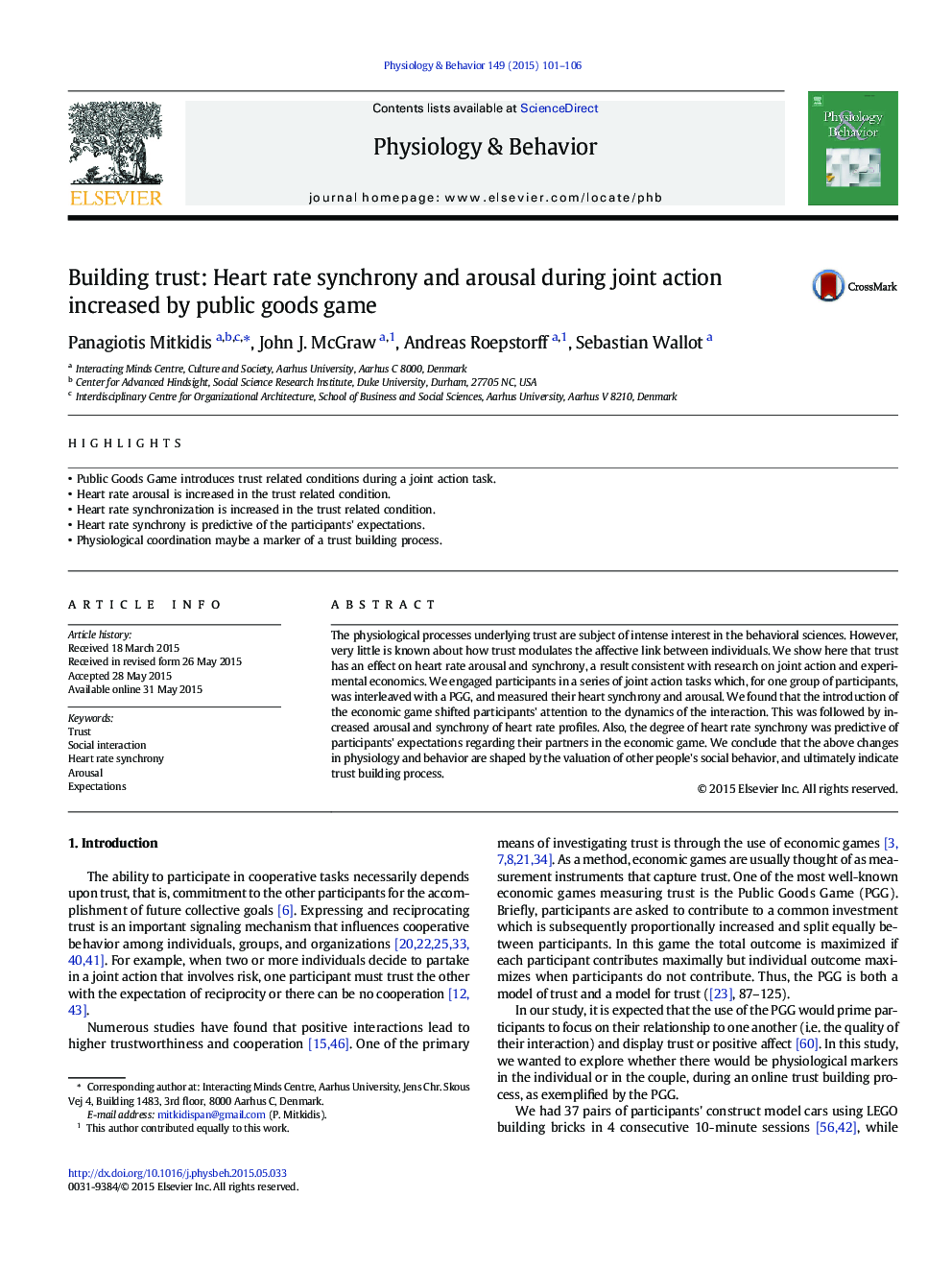 Building trust: Heart rate synchrony and arousal during joint action increased by public goods game