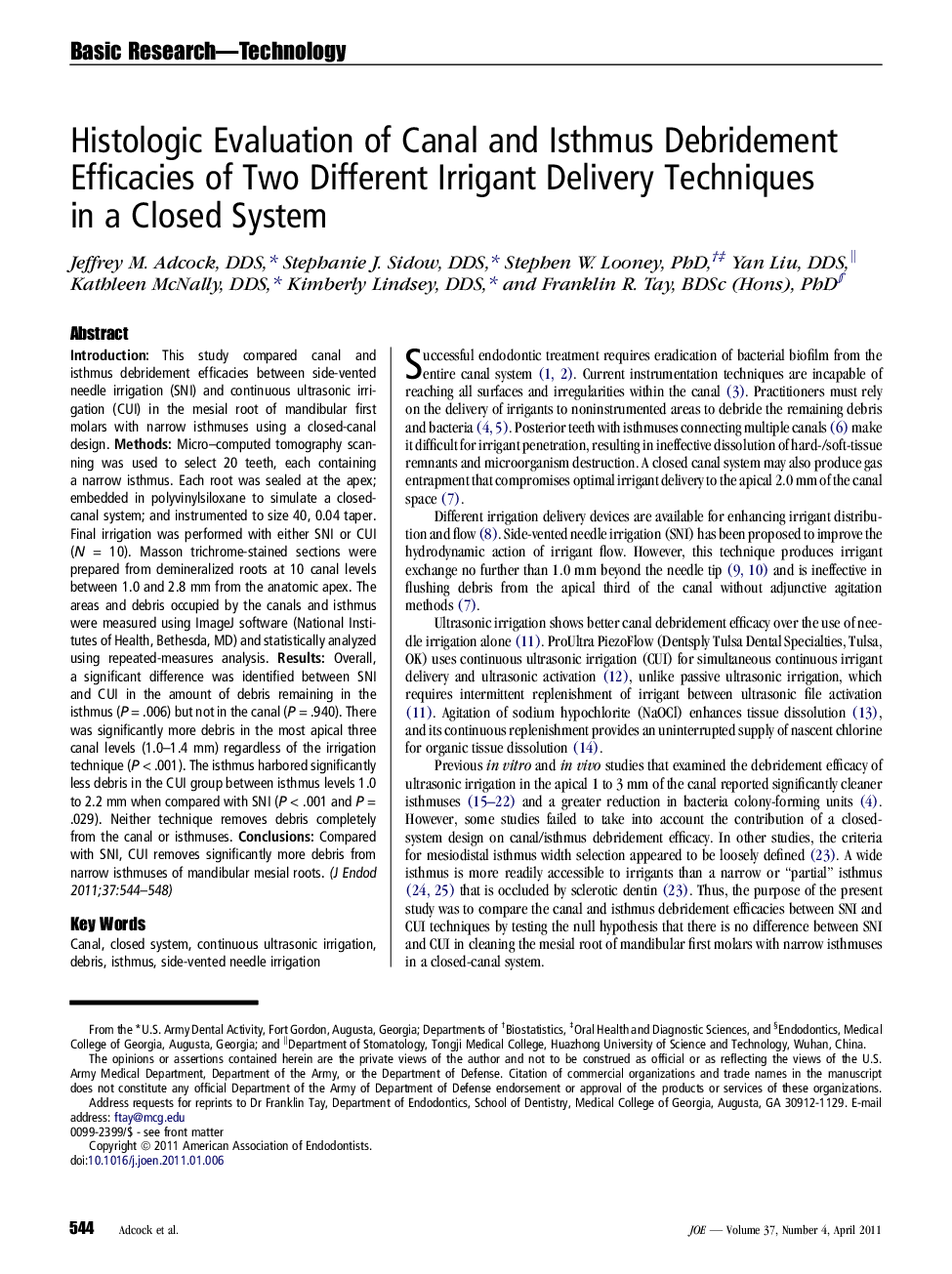 Histologic Evaluation of Canal and Isthmus Debridement Efficacies of Two Different Irrigant Delivery Techniques in a Closed System