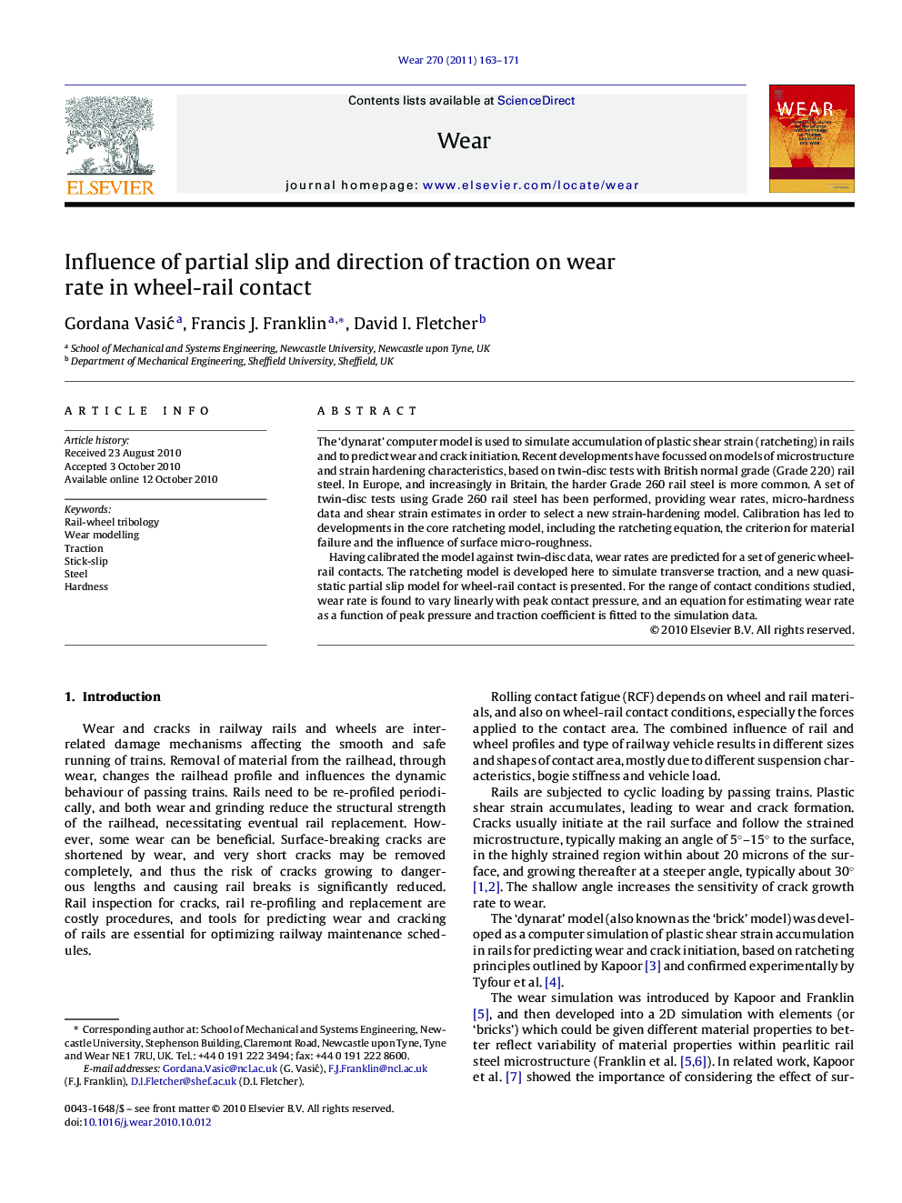 Influence of partial slip and direction of traction on wear rate in wheel-rail contact