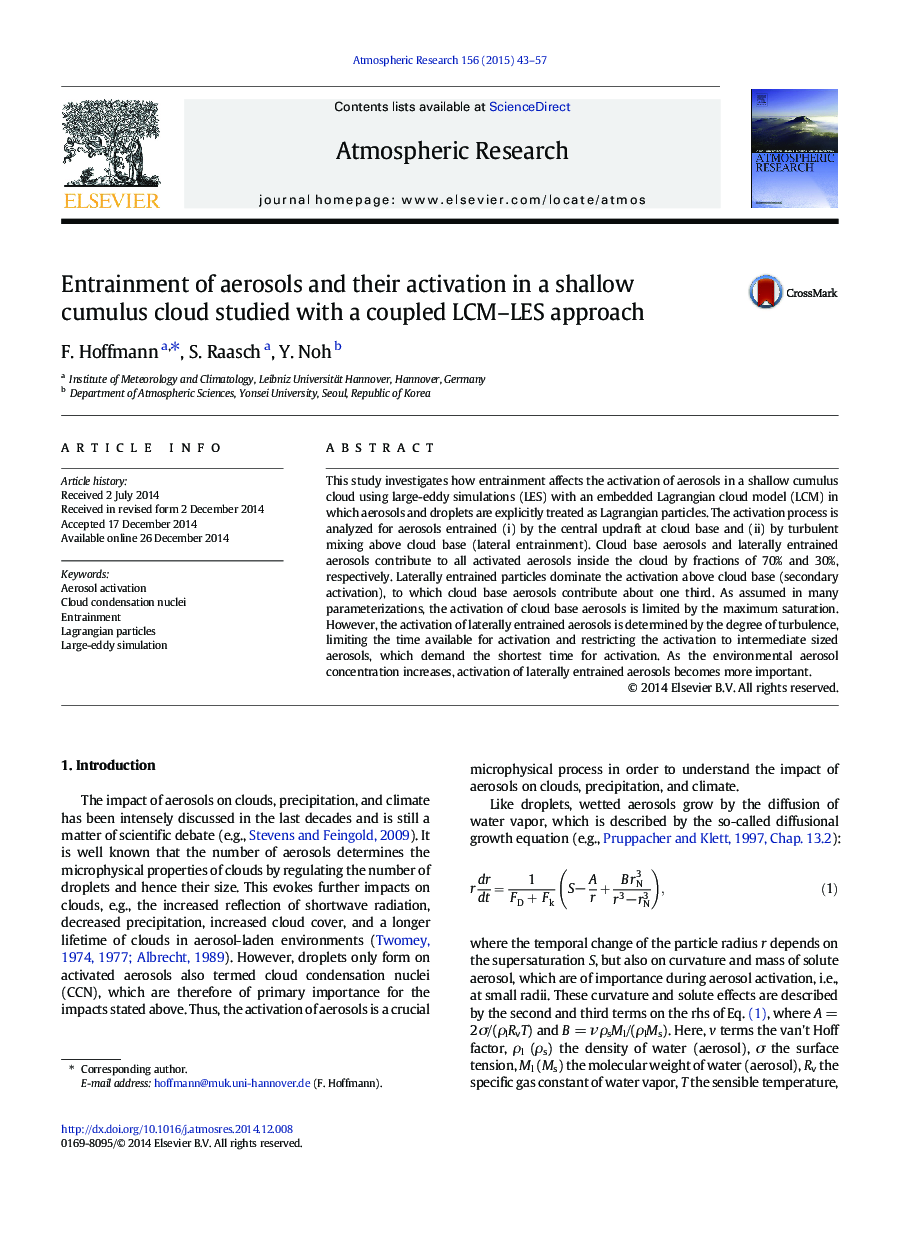 Entrainment of aerosols and their activation in a shallow cumulus cloud studied with a coupled LCM-LES approach