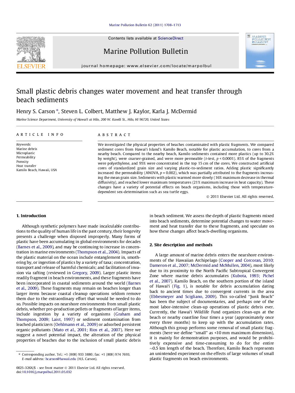 Small plastic debris changes water movement and heat transfer through beach sediments