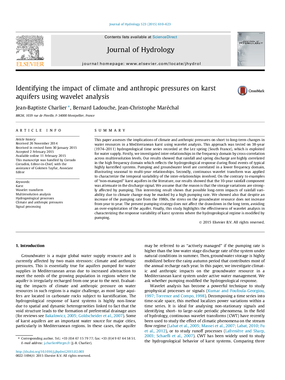 Identifying the impact of climate and anthropic pressures on karst aquifers using wavelet analysis